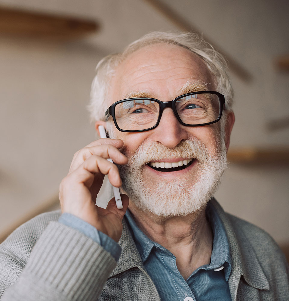 person on the phone smiling and talking