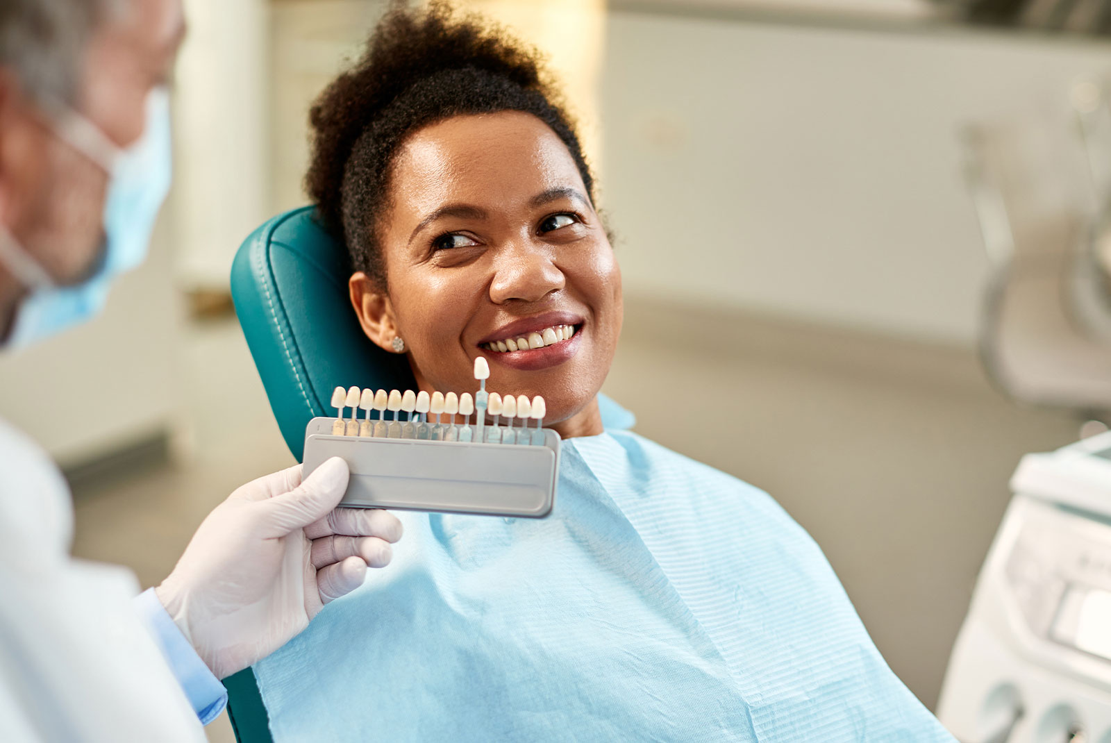 patient having veneers being shown to her within the dental center