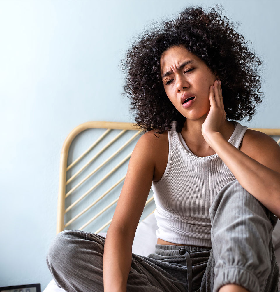 person waking up with mouth pain