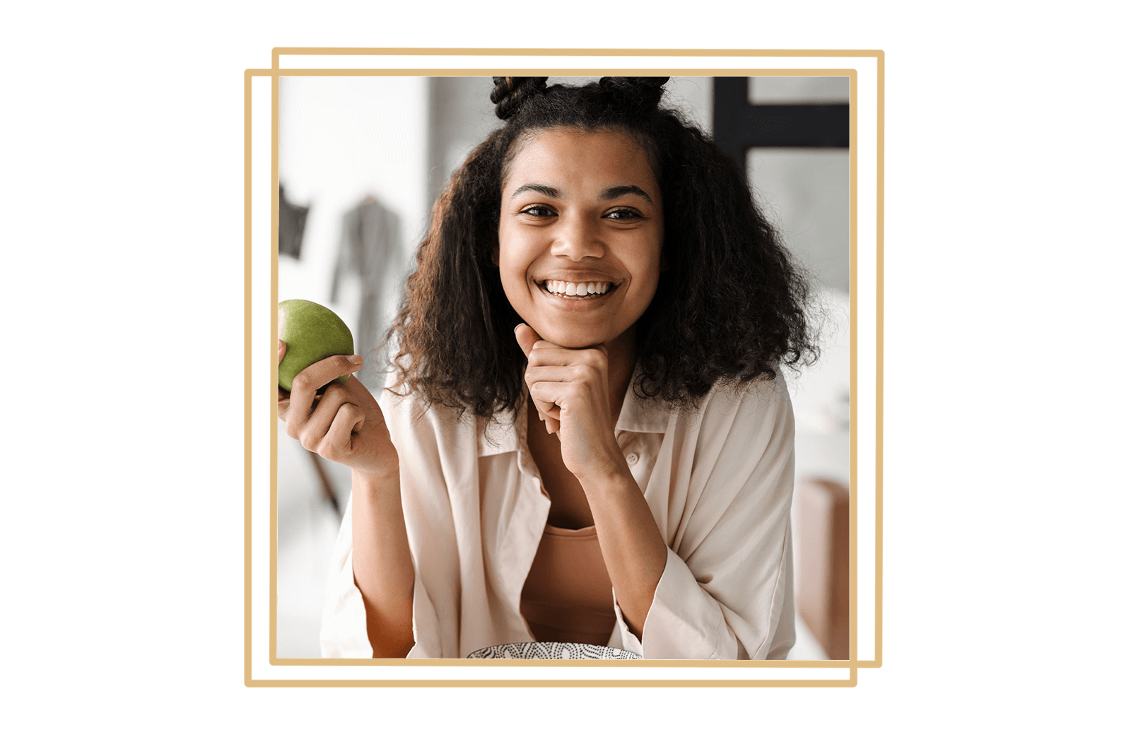 Person smiling brightly while enjoying a granny smith apple