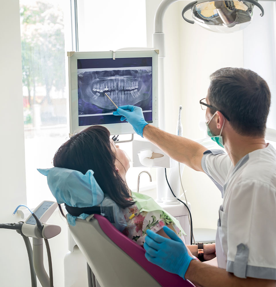 Doctor dentist showing patient's teeth on X-ray