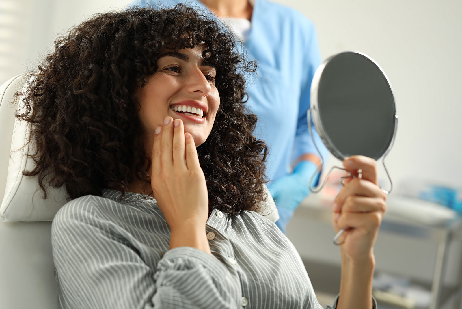 Patient looking in mirror and doctor in clinic, selective focus