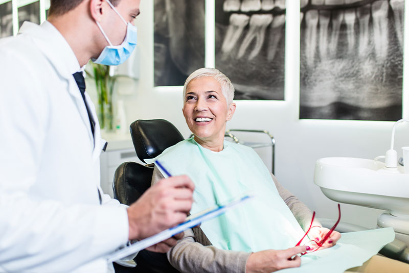 senior woman at dentist's office satisfied after successful dental treatment