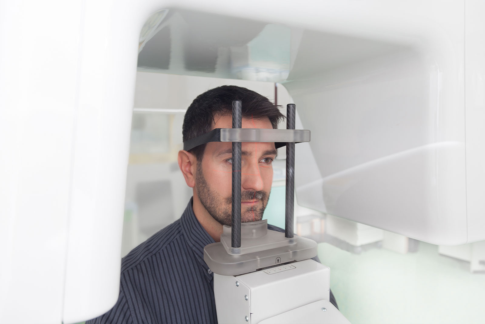 man having panoramic digital x-ray of his teeth.
