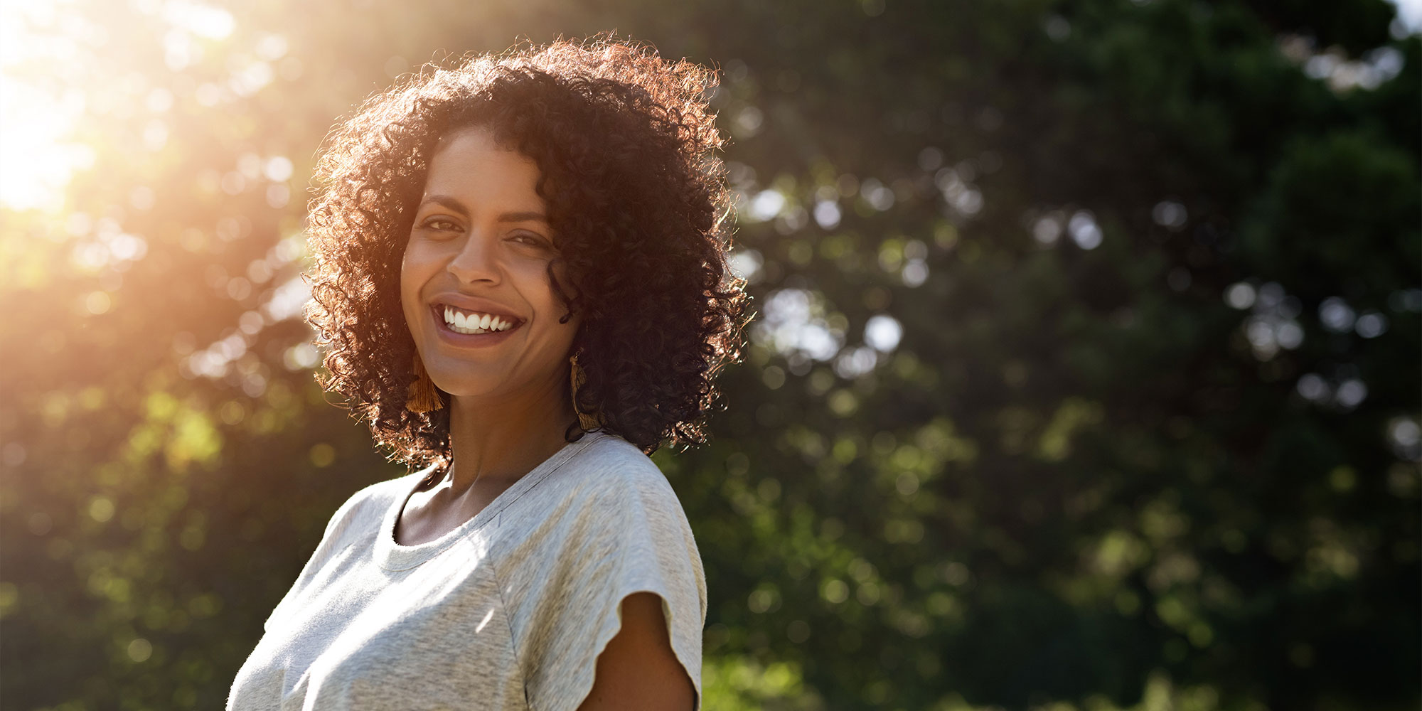 person smiling brightly while being outside