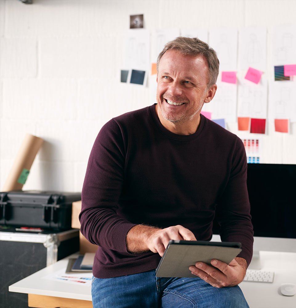man using tablet smiling