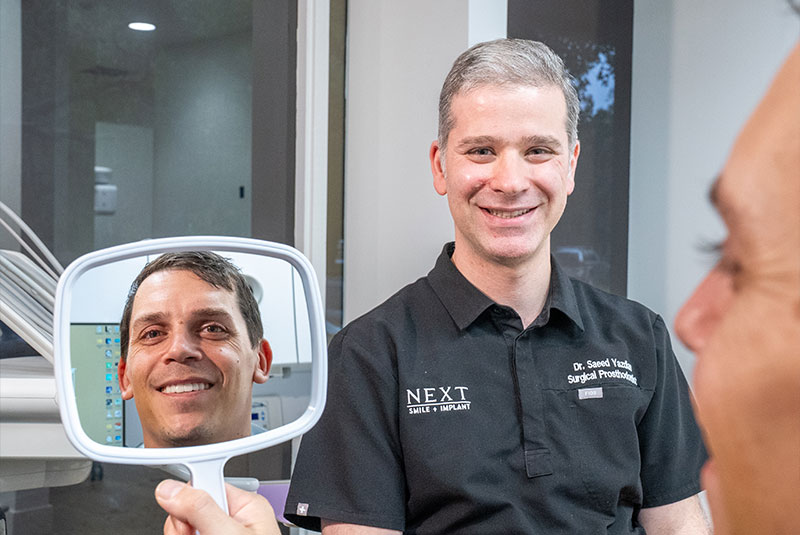 Patient Smiling into mirror